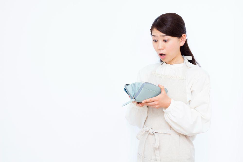 お財布の中身を見て驚く女性　シロアリ駆除費用